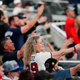 Braves fans perform the team’s trademark “Tomahawk Chop”.
